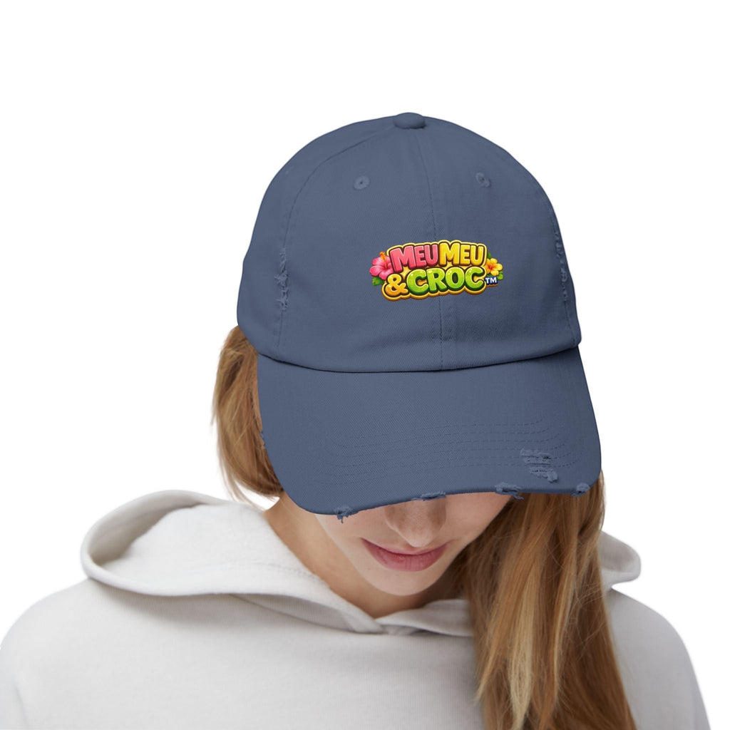 Woman wearing a blue Meu Meu & Croc Tropical Store distressed baseball cap with a colorful logo on a white background