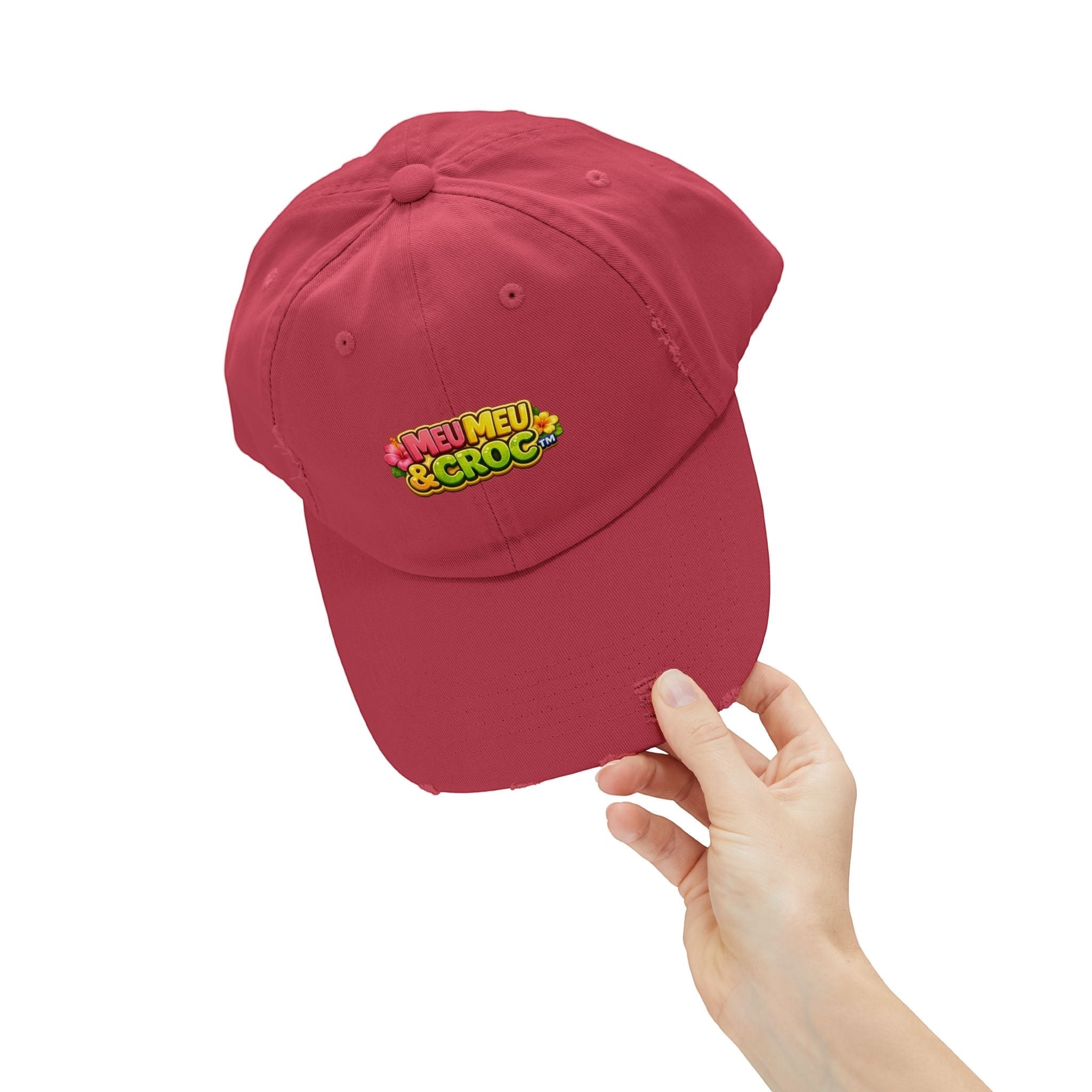 Red Meu Meu & Croc Tropical Store distressed baseball cap with embroidered logo held by a hand against white background