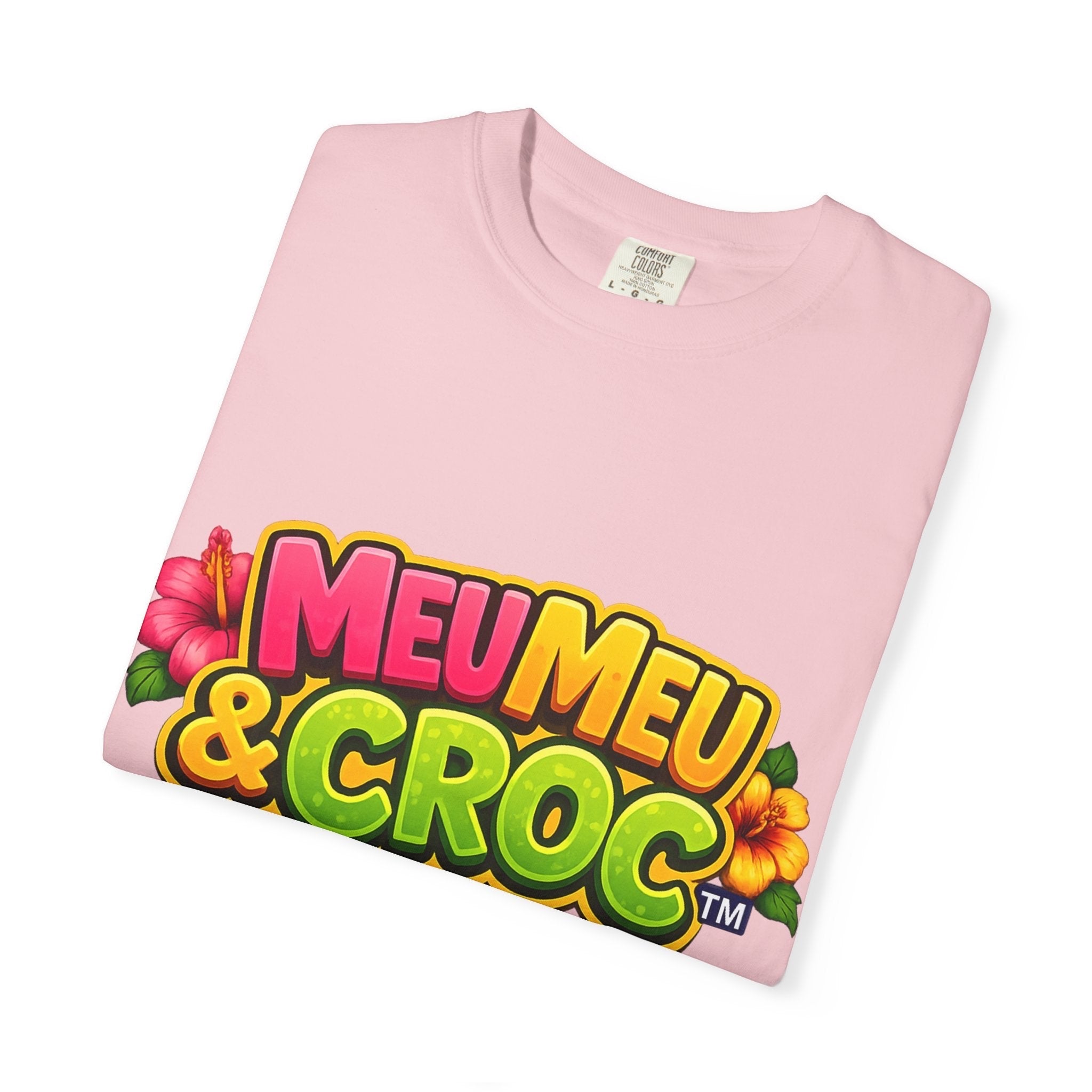 Meu Meu & Croc Tropical Store light pink graphic t-shirt with colorful logo and tropical hibiscus flower accents.