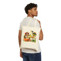 Model wearing a natural Meu Meu & Croc Tropical Store canvas tote bag with sloth and crocodile beach graphic print.
